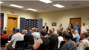 Rand Paul Stands Aside While a Campaign Aide Solicits Support with Lapel Pins