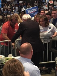 Sanders breaks through the gates to see his bleacher section