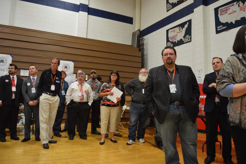 Candidates for national delegates await their turn to speak