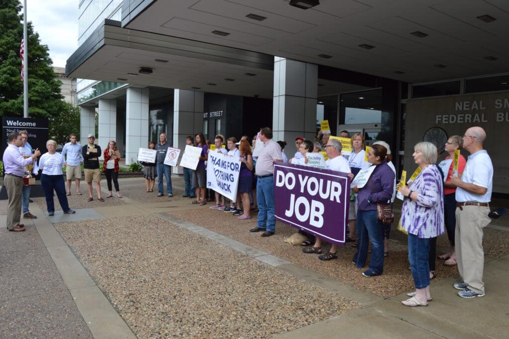 Iowans protested outside of Grassley's six Iowa offices on Tuesday