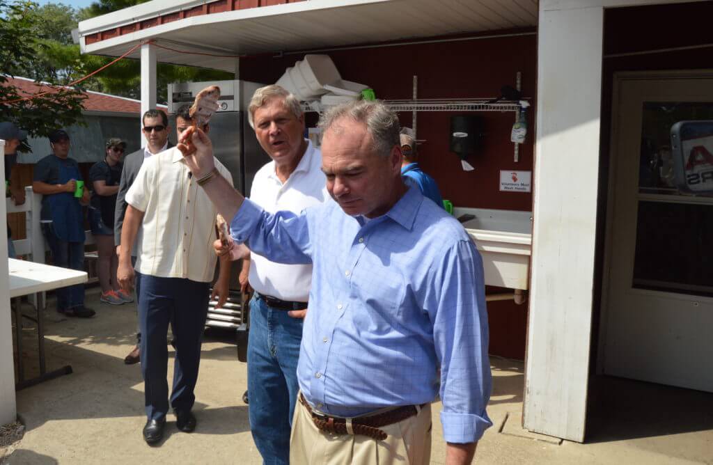 Tim Kaine holds up his pork chop for all to see